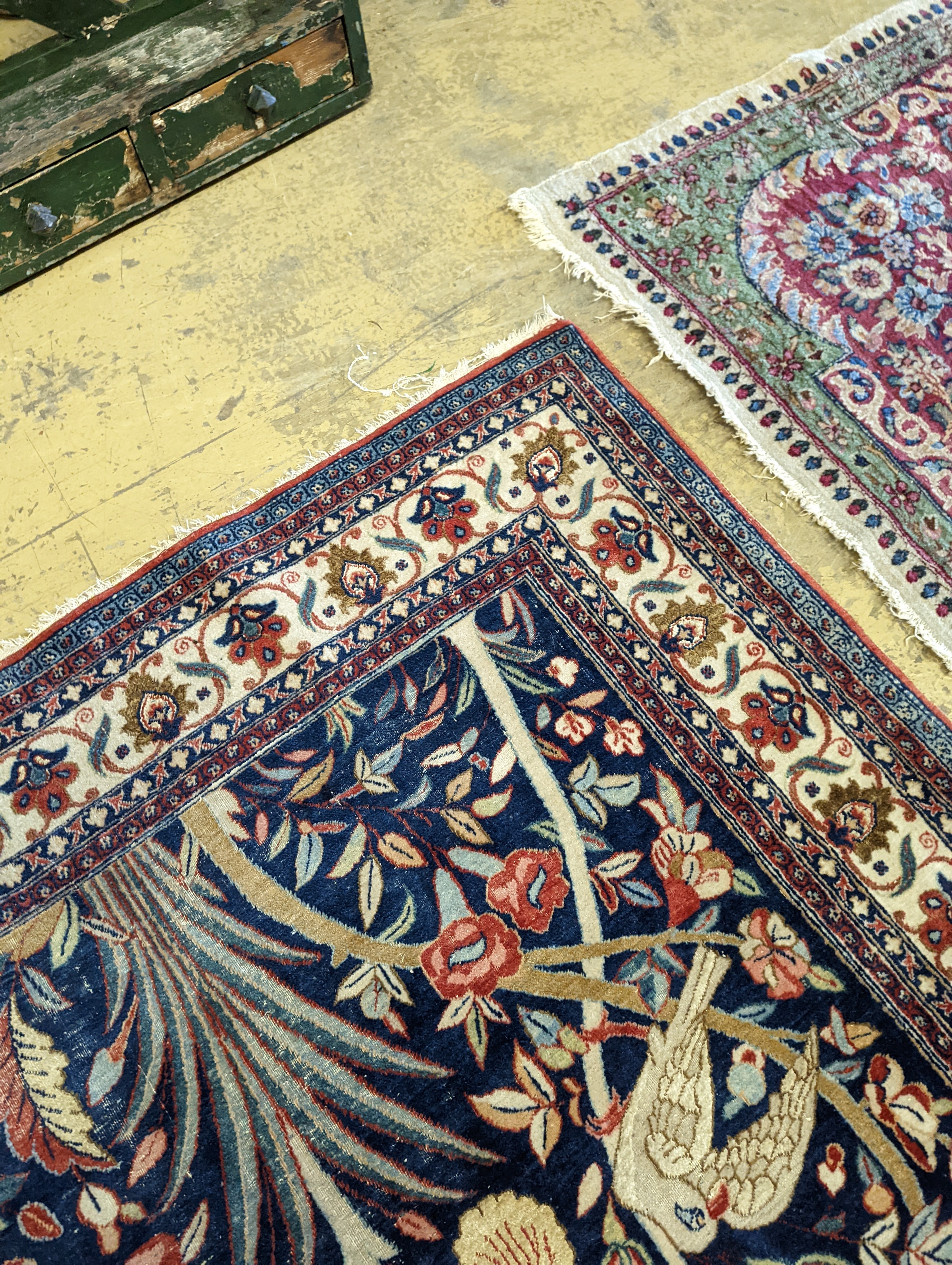 A Kirman blue ground rug woven with birds amongst flowering branches, 205 x 136cm